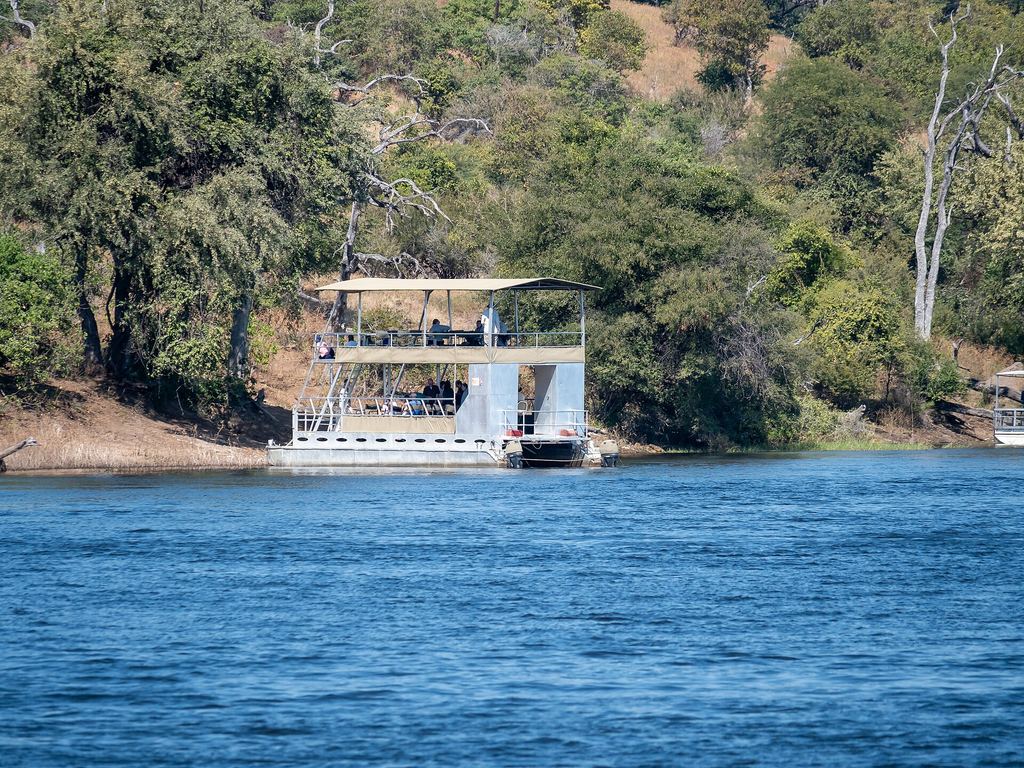Small safari boat on the Chobe River near Kasane, Botswana