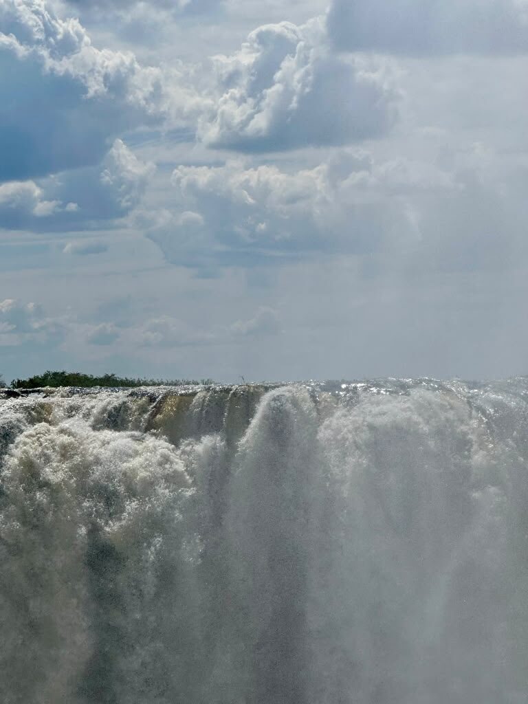 Spray rising from the crest of Victoria Falls as the river drops into the gorge