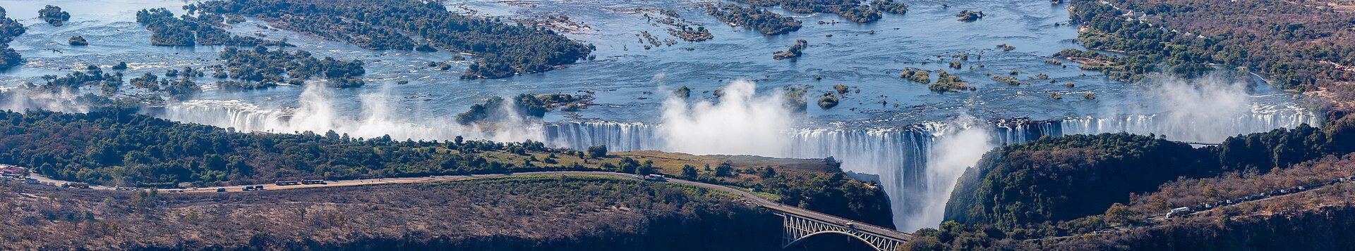 Panoramic view of Victoria Falls on the Zambezi River, with spray rising from the full width of the gorge